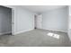 Cozy bedroom featuring neutral walls, plush carpet, and closet with a view of the front yard at 5812 Timber Ridge Dr, Raleigh, NC 27609