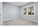 Cozy bedroom with a large window for natural light and plush carpet at 5812 Timber Ridge Dr, Raleigh, NC 27609