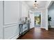 Stylish foyer with wood flooring, decorative console table, and contemporary lighting at 5812 Timber Ridge Dr, Raleigh, NC 27609