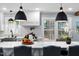 Bright kitchen with island, marble countertops, stainless steel appliances, and backyard view at 5812 Timber Ridge Dr, Raleigh, NC 27609