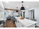 Open concept kitchen with island, marble countertops, stainless appliances, and an open living space at 5812 Timber Ridge Dr, Raleigh, NC 27609