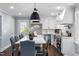 Bright kitchen featuring stainless steel appliances, white cabinets, and large island at 5812 Timber Ridge Dr, Raleigh, NC 27609