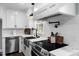 Modern kitchen featuring stainless steel appliances, white cabinets, and marble countertops at 5812 Timber Ridge Dr, Raleigh, NC 27609