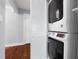 Laundry closet with stacked washer and dryer and folding door at 5812 Timber Ridge Dr, Raleigh, NC 27609