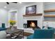 Cozy living room featuring a lit fireplace and custom mantel and built in at 5812 Timber Ridge Dr, Raleigh, NC 27609