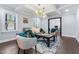 Bright living room featuring a coffered ceiling, modern lighting, and stylish furniture at 5812 Timber Ridge Dr, Raleigh, NC 27609