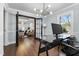Contemporary office with views into living space and modern lighting at 5812 Timber Ridge Dr, Raleigh, NC 27609