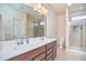 Bathroom featuring double vanity, white countertops, and walk-in shower at 590 Grand Central Sta, Apex, NC 27502