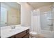 Clean bathroom with tub, shower, white shower curtain, toilet, vanity with mirror, and neutral color palette at 590 Grand Central Sta, Apex, NC 27502