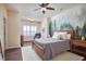 Cozy bedroom with wood-look bed frame, ceiling fan, and natural light at 590 Grand Central Sta, Apex, NC 27502