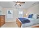 Comfortable bedroom with a wooden bed frame, ceiling fan, and bright white shutters at 590 Grand Central Sta, Apex, NC 27502