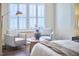 Bedroom seating area with armchairs, side table, stylish lamp, and plantation shutters at 590 Grand Central Sta, Apex, NC 27502
