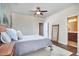 Bedroom featuring wood-look bed frame, ensuite bathroom, and natural light at 590 Grand Central Sta, Apex, NC 27502