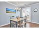 Light-filled dining room with hardwood floors, modern chandelier, and access to outdoor space at 590 Grand Central Sta, Apex, NC 27502