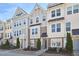 Charming townhome exteriors featuring varied siding, manicured landscaping, and inviting entrances at 590 Grand Central Sta, Apex, NC 27502