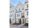 Beautiful townhome exteriors showcasing varied siding, architectural details, and well-maintained landscaping at 590 Grand Central Sta, Apex, NC 27502
