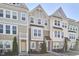 Charming townhomes feature varied exteriors, manicured lawns, and inviting entryways, creating a welcoming street view at 590 Grand Central Sta, Apex, NC 27502