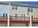 Rear view of townhome featuring wood decks and garage entrances, offering a functional and modern design at 590 Grand Central Sta, Apex, NC 27502
