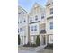 Inviting townhome exteriors boast detailed architecture, stone accents, and well-maintained landscaping for curb appeal at 590 Grand Central Sta, Apex, NC 27502