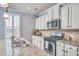 Bright kitchen with white cabinets, granite countertops, and stainless steel appliances at 590 Grand Central Sta, Apex, NC 27502