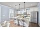 Bright, modern kitchen with stainless steel appliances, granite island, and ample seating perfect for cooking and dining at 590 Grand Central Sta, Apex, NC 27502