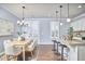 Charming kitchen and dining area featuring modern lighting, granite countertops, and ample seating for casual dining at 590 Grand Central Sta, Apex, NC 27502
