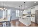 Bright, modern kitchen with granite countertops, stainless steel appliances, and an adjacent dining area at 590 Grand Central Sta, Apex, NC 27502