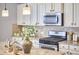 Well-lit kitchen boasting granite countertops, stainless steel appliances, and stylish pendant lighting at 590 Grand Central Sta, Apex, NC 27502