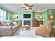 Inviting living room with a cozy fireplace, stylish furniture, and abundant natural light from the windows at 590 Grand Central Sta, Apex, NC 27502