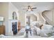 Comfortable living space with a fireplace, plush seating, and open layout to stairs offering a cozy retreat at 590 Grand Central Sta, Apex, NC 27502