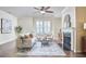 Bright living room with a cozy fireplace, elegant decor, and hardwood floors, perfect for relaxing and entertaining at 590 Grand Central Sta, Apex, NC 27502