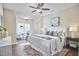 Serene bedroom featuring hardwood floors, a ceiling fan, and a comfortable seating area near the window at 590 Grand Central Sta, Apex, NC 27502
