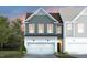 Two-story home featuring a two-car garage, hardiplank siding and a covered front porch at 6001 Enclosure Way, Durham, NC 27703
