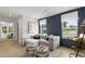 Comfortable living room featuring neutral décor and ample seating with large windows and natural light at 6002 Enclosure Way, Durham, NC 27703