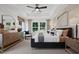 Spacious primary bedroom features tray ceiling, a ceiling fan, and large window at 6002 Enclosure Way, Durham, NC 27703