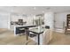 Modern eat-in kitchen with a glass table, bar stool seating, and stainless steel appliances at 6019 Enclosure Way, Durham, NC 27703