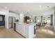 Open-concept kitchen with quartz countertops, stainless appliances, and a view of the living area at 6019 Enclosure Way, Durham, NC 27703
