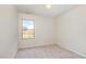 An empty bedroom with neutral carpet with one window providing natural light at 627 Hastings Rd, Mebane, NC 27302