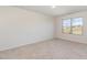 Bright, carpeted bedroom with a window offering neighborhood views and ample natural light at 627 Hastings Rd, Mebane, NC 27302