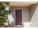Close-up of a deep red front door with matching trim and green foliage to the side at 627 Hastings Rd, Mebane, NC 27302