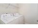 Laundry area with white washer and dryer and shelving overhead at 627 Hastings Rd, Mebane, NC 27302