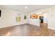 Open concept living room with hardwood floors, flowing into a modern kitchen at 627 Hastings Rd, Mebane, NC 27302