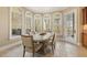 Bright dining area featuring large arched windows, a tiled floor, and a patio exit at 6452 Therfield Dr, Raleigh, NC 27614