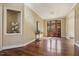 Elegant foyer with hardwood floors, detailed trim, and a view through wooden framed glass paneled doors at 6452 Therfield Dr, Raleigh, NC 27614