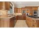 Spacious kitchen with wood cabinetry, stainless steel appliances, and granite countertops at 6452 Therfield Dr, Raleigh, NC 27614