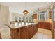 Large kitchen island with granite countertop and wooden cabinetry in a bright and airy space at 6452 Therfield Dr, Raleigh, NC 27614