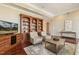 Spacious living room with built-in shelving, hardwood floors, and a comfortable seating area at 6452 Therfield Dr, Raleigh, NC 27614