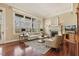 Elegant living room featuring a fireplace, hardwood floors, and a wall of windows at 6452 Therfield Dr, Raleigh, NC 27614
