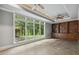 Sunroom with a wall of windows overlooking landscaped backyard at 6452 Therfield Dr, Raleigh, NC 27614