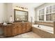 Luxurious main bathroom with double vanity, soaking tub, and elegant tile work at 6452 Therfield Dr, Raleigh, NC 27614